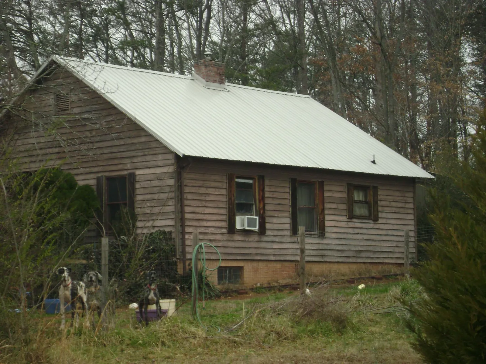 White metal roof on an old wood sided farmhouse, from a Metal Roof Installation job in Aberdeen